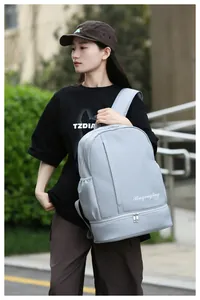 Outdoor shot of a light blue large travel backpack with separate wet dry storage design