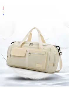 Close-up of cream travel bag with multi-pocket system and lightweight nylon fabric