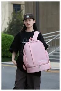 Outdoor shot of pink travel backpack featuring dual-layer storage and side pockets