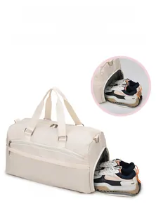 Detailed view of the independent shoe compartment on the large beige waterproof travel bag