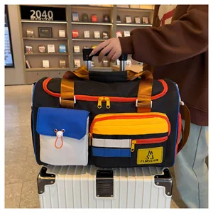 Close-up of color-block travel bag with wheels and telescopic handle on luggage
