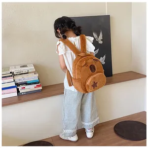 Detail view of a plush Capybara backpack featuring a small star pocket on a brown furry body