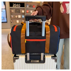 Detail view of the travel bag rear trolley sleeve secured on a white suitcase