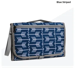 Close-up of waterproof portable baby diaper changing pad with blue arrow pattern texture