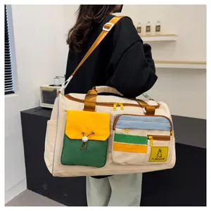 Detailed view of travel bag with yellow shoulder strap and colorful utility pockets