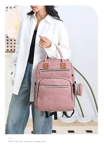 Pink quilted backpack with a matching round pouch shown in a stylish home setting