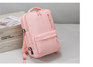 Detail of pink laptop backpack showing USB charging port and breathable mesh padding