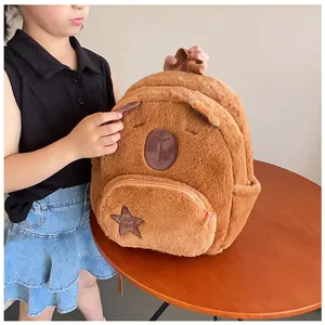 Close-up of cute brown plush capybara backpack with embroidery and star pocket detail