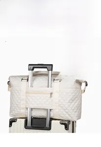 Detail view of the travel bag featuring a back trolley sleeve and zipper pocket