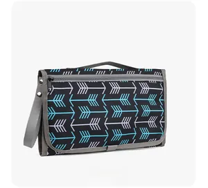Detail of portable waterproof baby changing pad with blue geometric arrow pattern