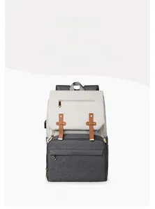 Front view of large capacity diaper bag with contrast tones and leather buckle detail