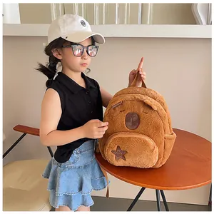 Detail of cute Capybara plush backpack with star embroidery on a small girl