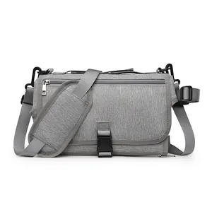 Portable gray baby diaper changing mat bag with adjustable padded shoulder strap