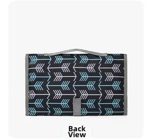 Back view of foldable portable baby changing mat with blue arrow pattern and handle