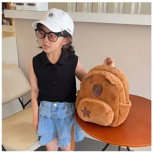 Detail of cute Capybara plush backpack with star embroidery on a young girl model