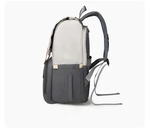 Side angle view of multifunctional diaper backpack with USB port and gray waterproof nylon fabric