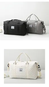 Detail of quilted travel bags with adjustable straps in black, gray, and cream colors