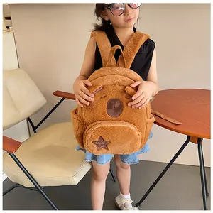 Detailed close-up of brown plush capybara backpack featuring soft fur and star embroidery