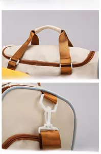 Detail showing reinforced beige handles and durable blue piping on travel bag
