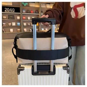 Detail showing the back luggage sleeve of the canvas travel bag attached to a suitcase handle