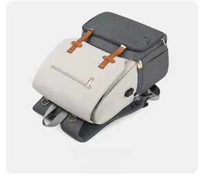 Top-down macro view of multifunctional diaper bag with USB port and gray fabric texture