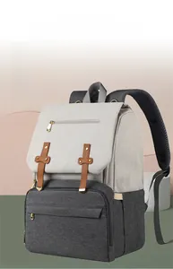 Detail of white and grey diaper bag with padded straps and USB port integration