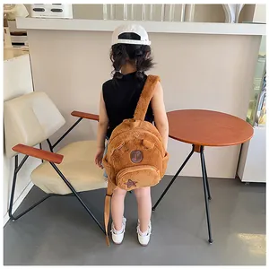 Detail of plush brown cartoon bear backpack with soft straps and embroidered star pocket