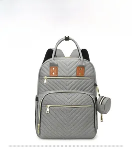Front view of grey quilted diaper backpack with thermal compartment and gold hardware