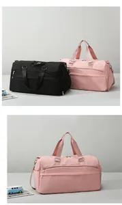 Detail view of large travel bags in black and pink with separate shoe compartments