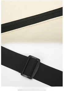 Close-up of durable beige fabric stitching and adjustable black shoulder strap buckle