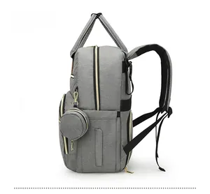 Side view of gray multifunctional diaper backpack with side pocket and small round coin purse