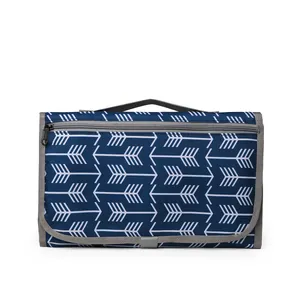 Portable waterproof diaper changing pad in navy blue with white arrow print and grey handle
