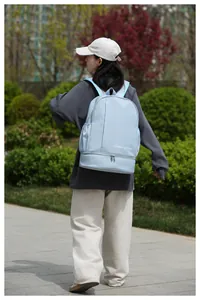 Outdoor shot of light blue travel backpack with wet dry separation bottom compartment