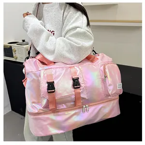 Detail view of pink pearlescent waterproof travel bag showing double buckle pockets and shoe compartment