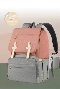 Pink and grey multi-functional diaper bag featuring side pockets and magnetic flap closure