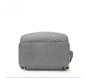 Detail view of the gray diaper bag bottom featuring reinforced V-shaped quilted stitching