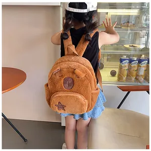 Detail view of cute plush capybara backpack with soft fabric and star embroidery on strap