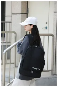 Detail of black dry-wet separation travel backpack featuring an independent shoe compartment