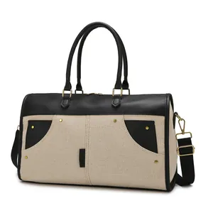 Large capacity canvas travel bag with durable black leather accents and shoulder strap