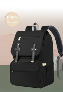Detailed view of black diaper backpack featuring decorative buckles and breathable straps