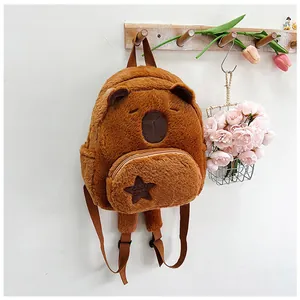 Detail of soft brown plush capybara backpack with star pocket and adjustable straps
