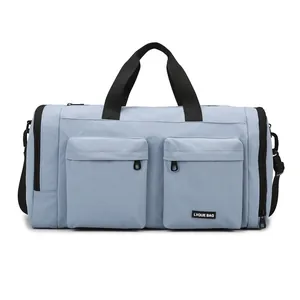 Blue travel duffel bag with multiple pockets, independent shoe compartment, and shoulder strap