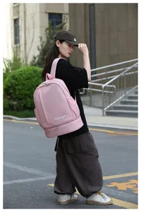 Pink waterproof travel backpack with separate bottom shoe compartment on street