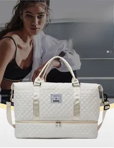 Quilted beige duffle bag featuring separate bottom compartment for shoes and wet items