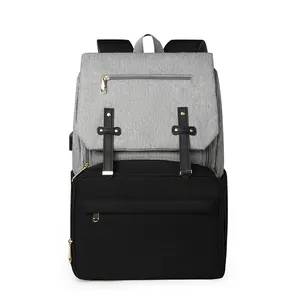 Grey and black diaper bag with USB port, gold rivet straps and multi-pocket design