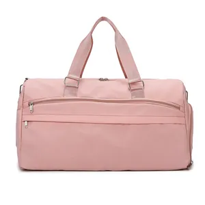 Large waterproof travel duffel bag in pink with shoe compartment for gym and sports