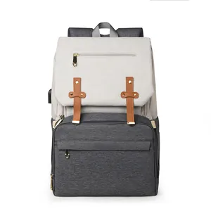 Multifunctional diaper backpack in grey patchwork with USB port and gold zippers