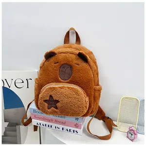 Detail view of plush brown capybara backpack featuring star embroidery and adjustable straps