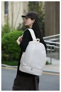 Side view of beige travel backpack with dry-wet separation and independent shoe compartment
