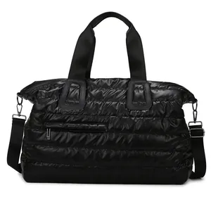 Quilted black fitness travel bag with waterproof nylon finish and dual shoulder straps
